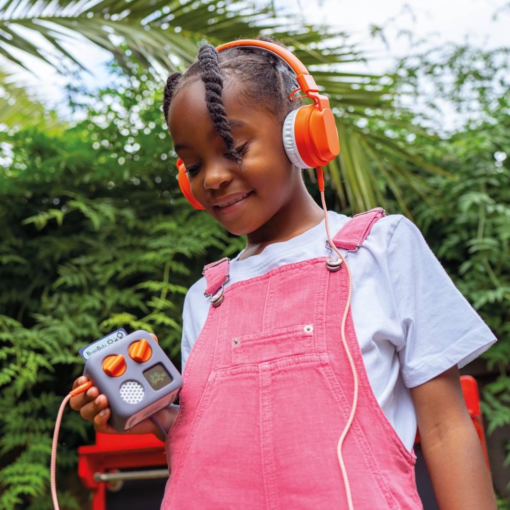 A child listening to Sea Defenders on Yoto Mini