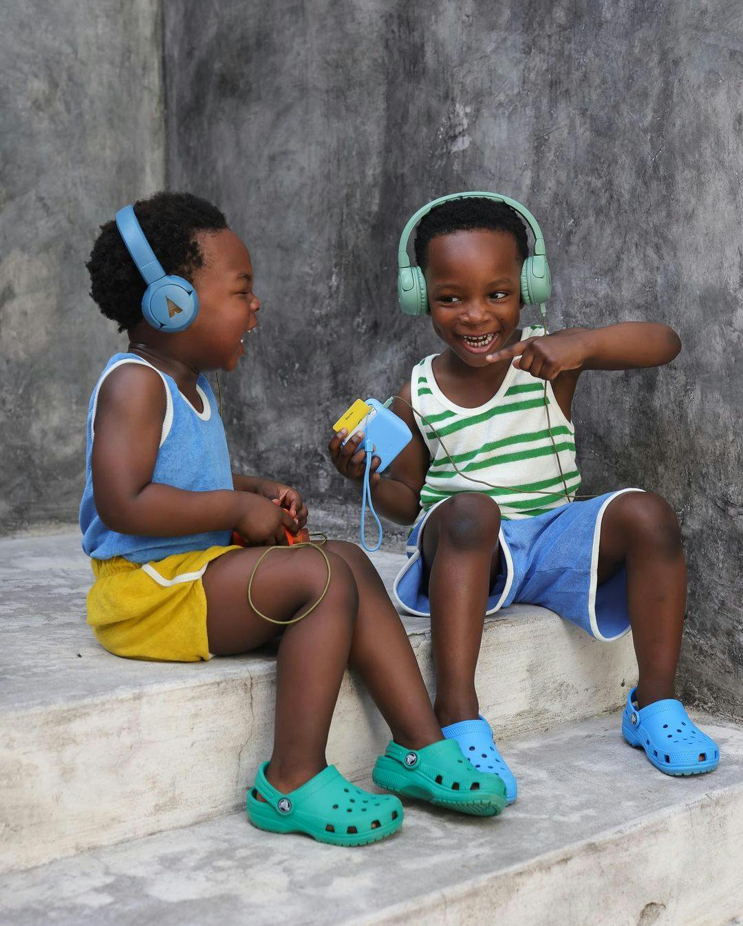 Two kids listening to their Yoto Mini through Wireless Headphones