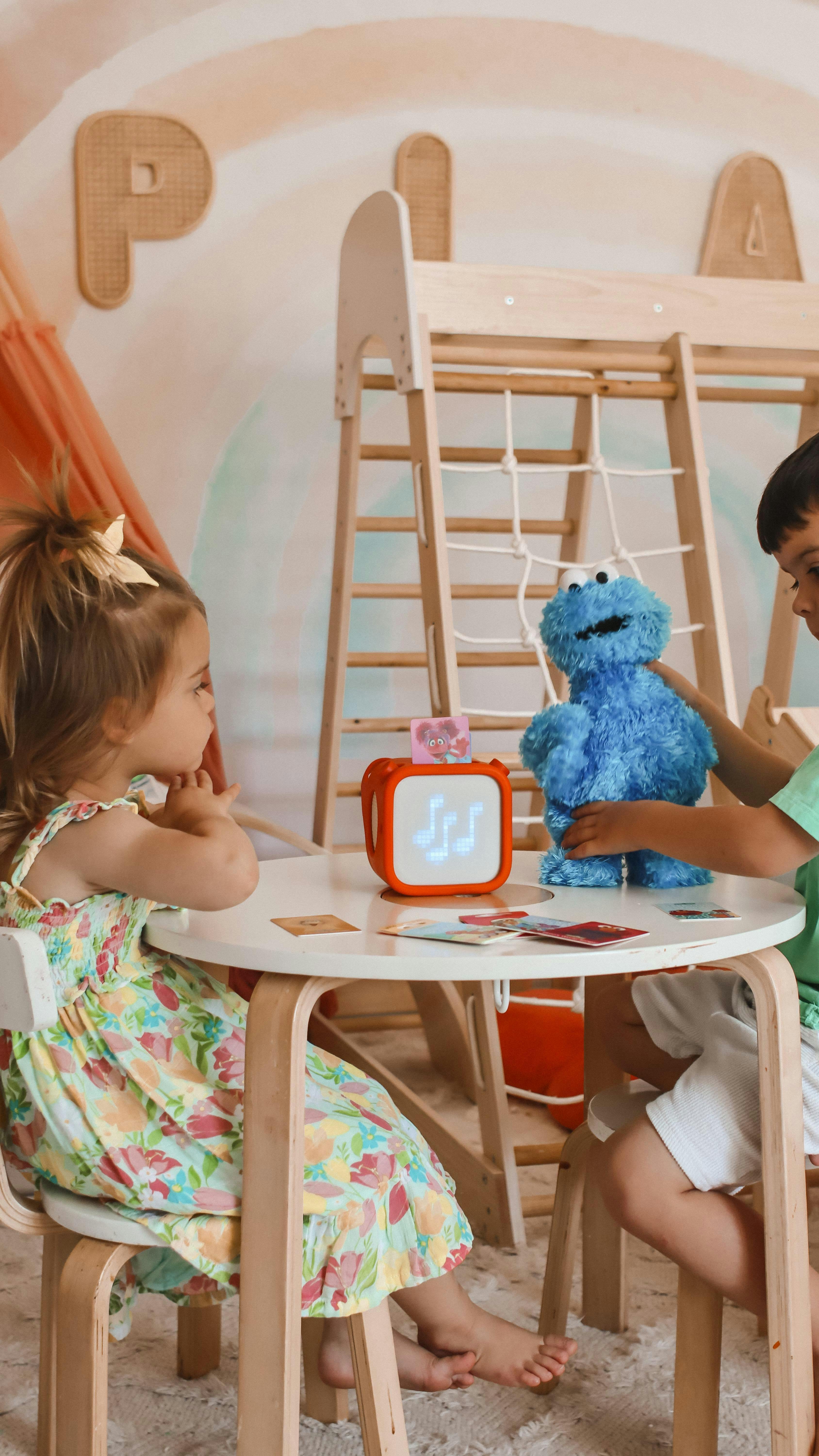 Two children at table with Yoto Player