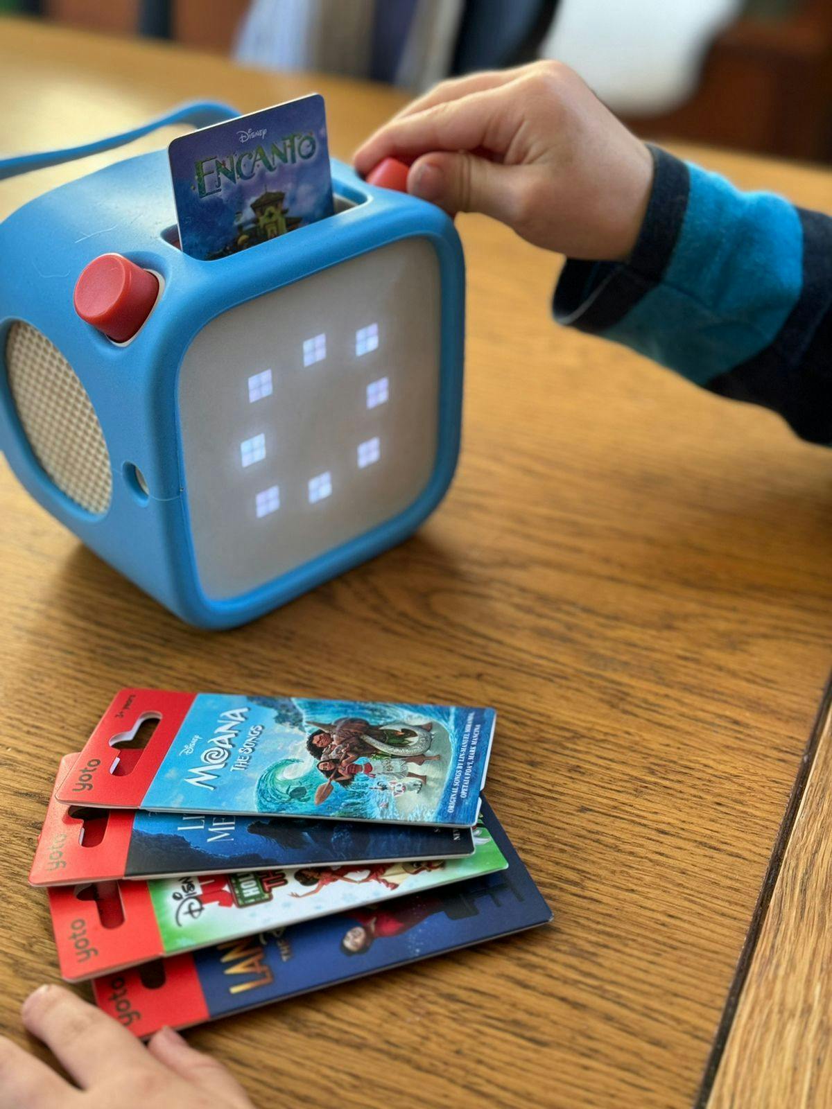 Child playing with Disney cards in Yoto Player