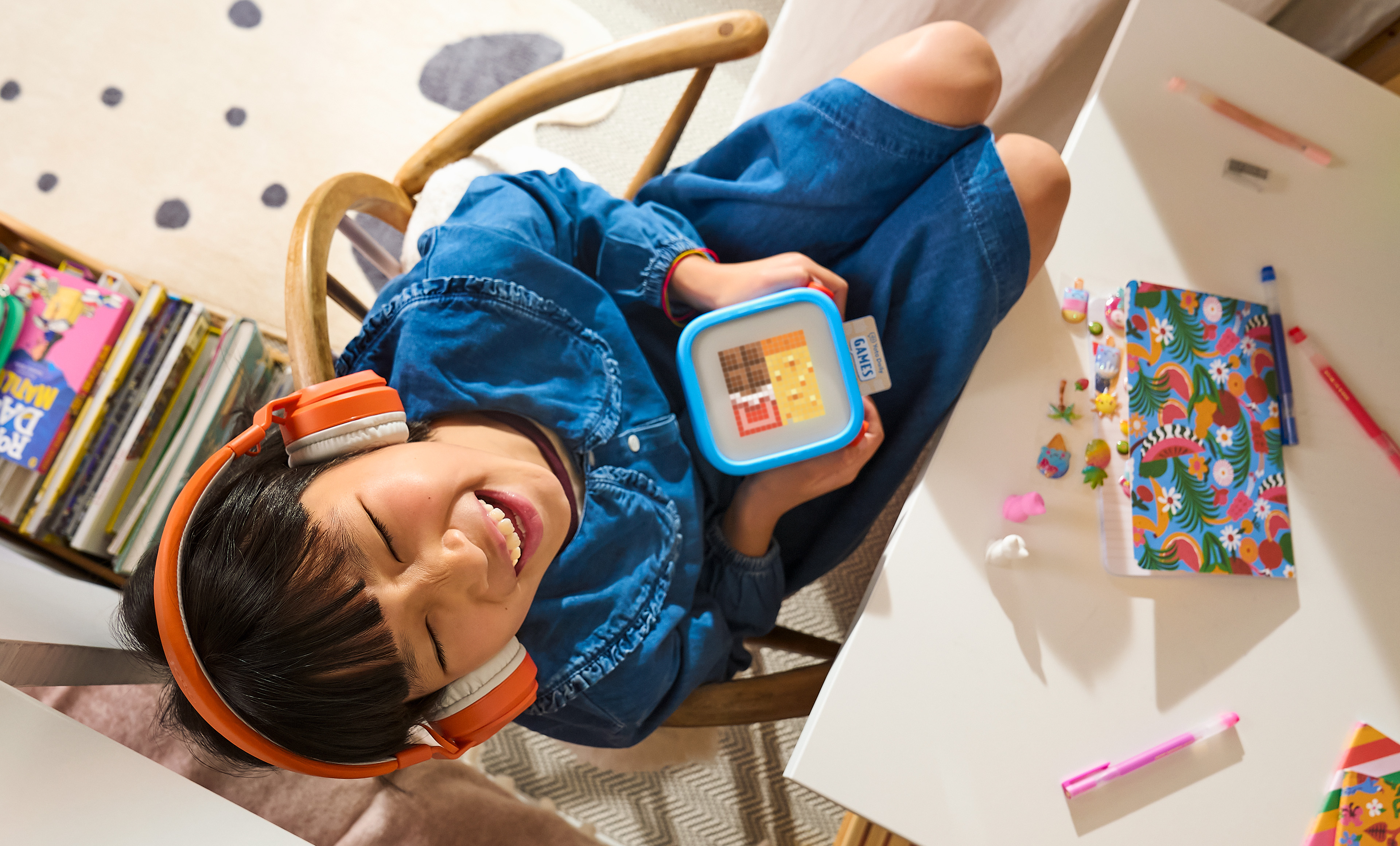 Child listening to Yoto player with headphones