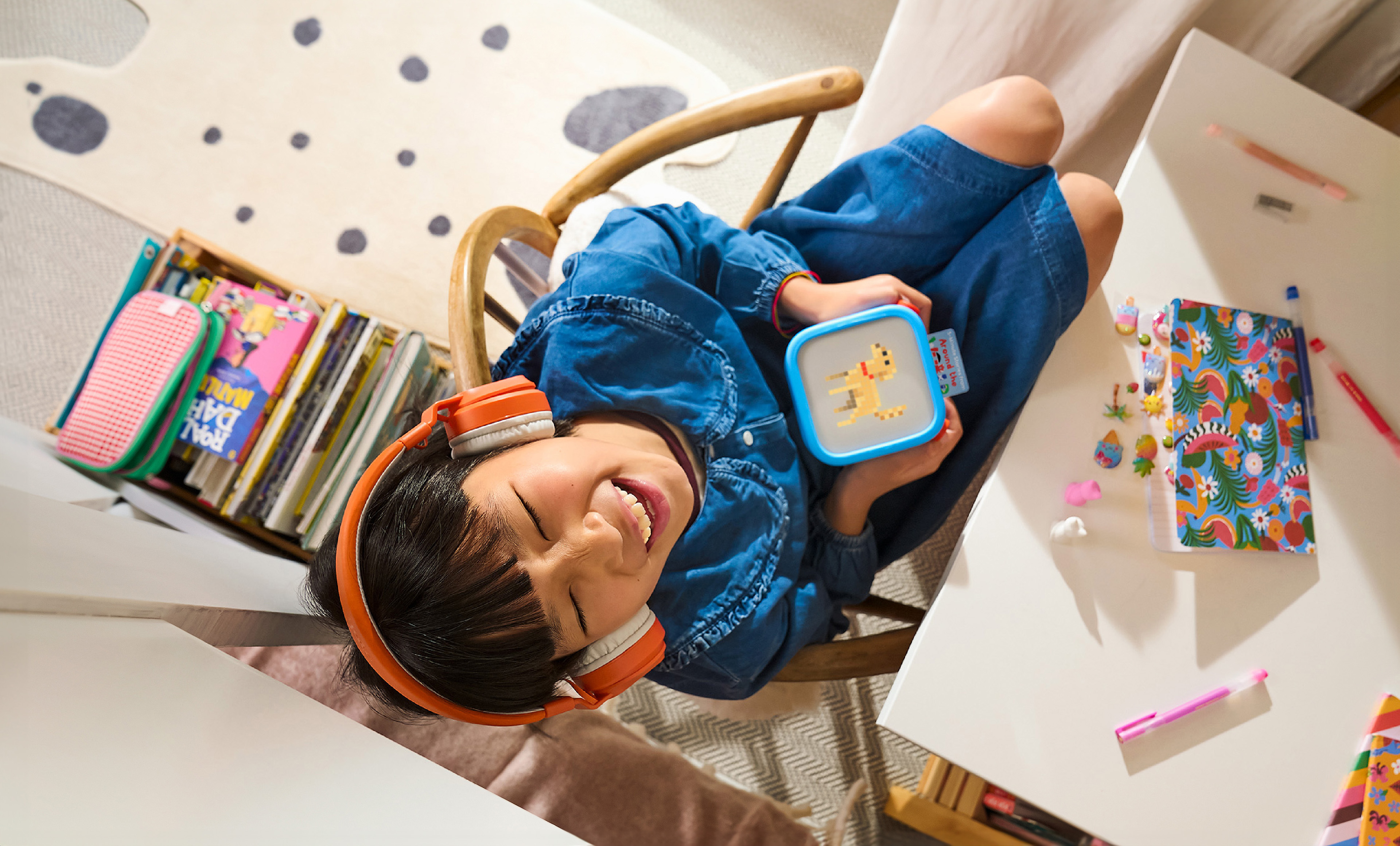 Child listening to Yoto player with headphones