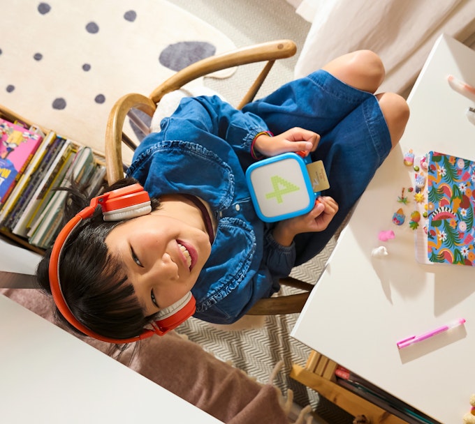 girl listening to yoto with headphones