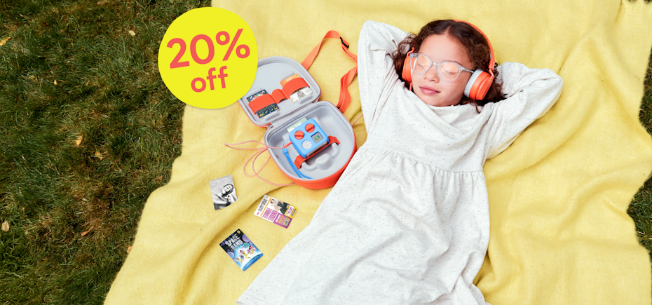Summer Sale - 20% off. Image shows a child listening to cards on the Yoto Mini sat inside the Yoto Mini Travel Case.