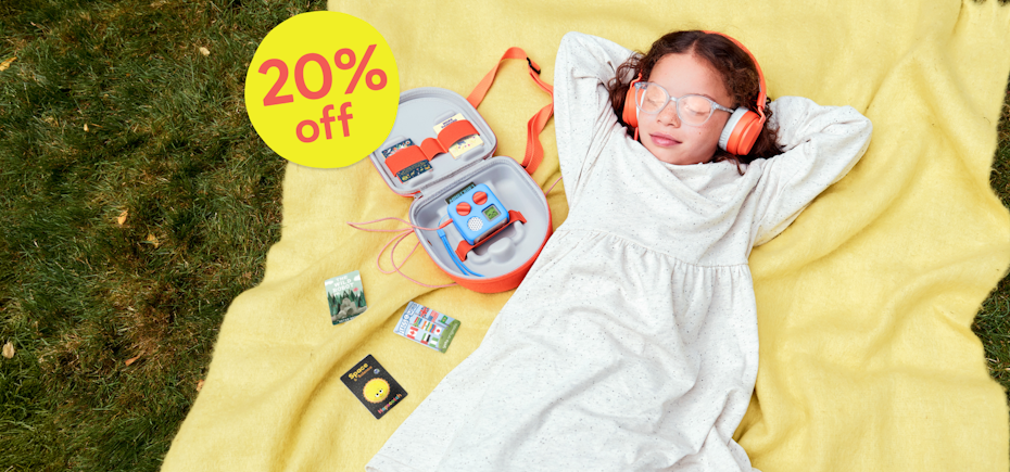 Summer Sale - 20% off. Image shows a child listening to cards on the Yoto Mini sat inside the Yoto Mini Travel Case.
