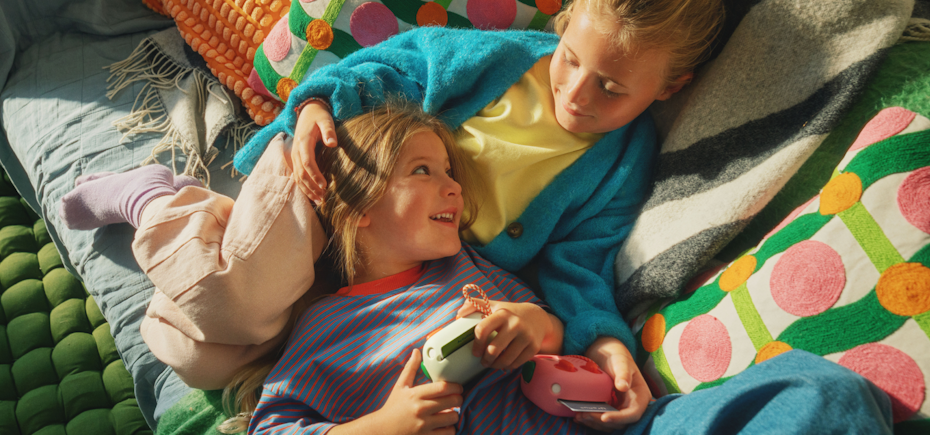 Two children holding a Yoto Mini 4th Gen Each