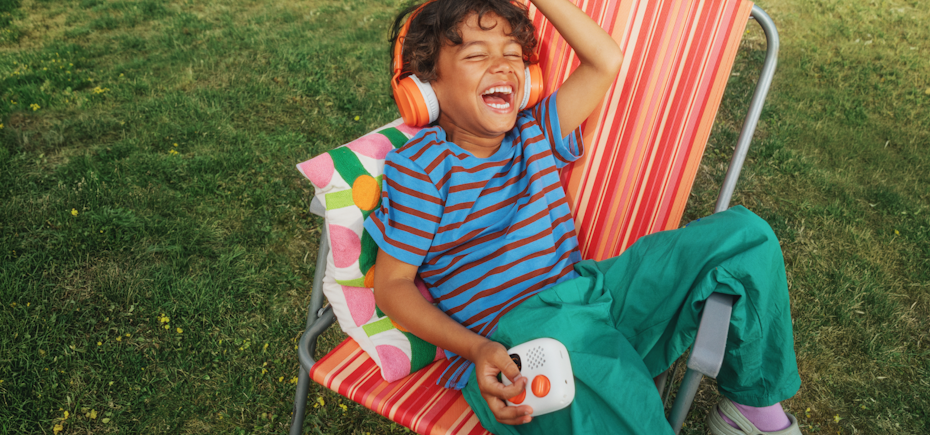 Child playing with a Yoto Mini Gen 4 in the garden