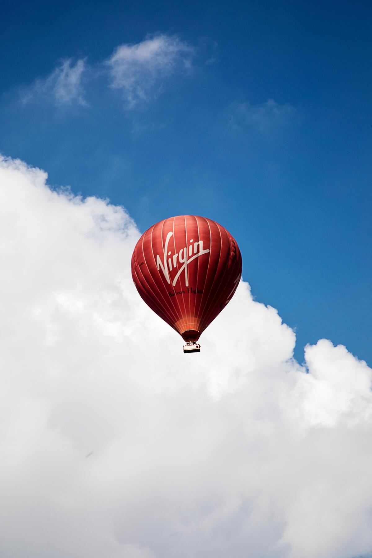 A red air balloon with Virgin’s logo floating up in the air