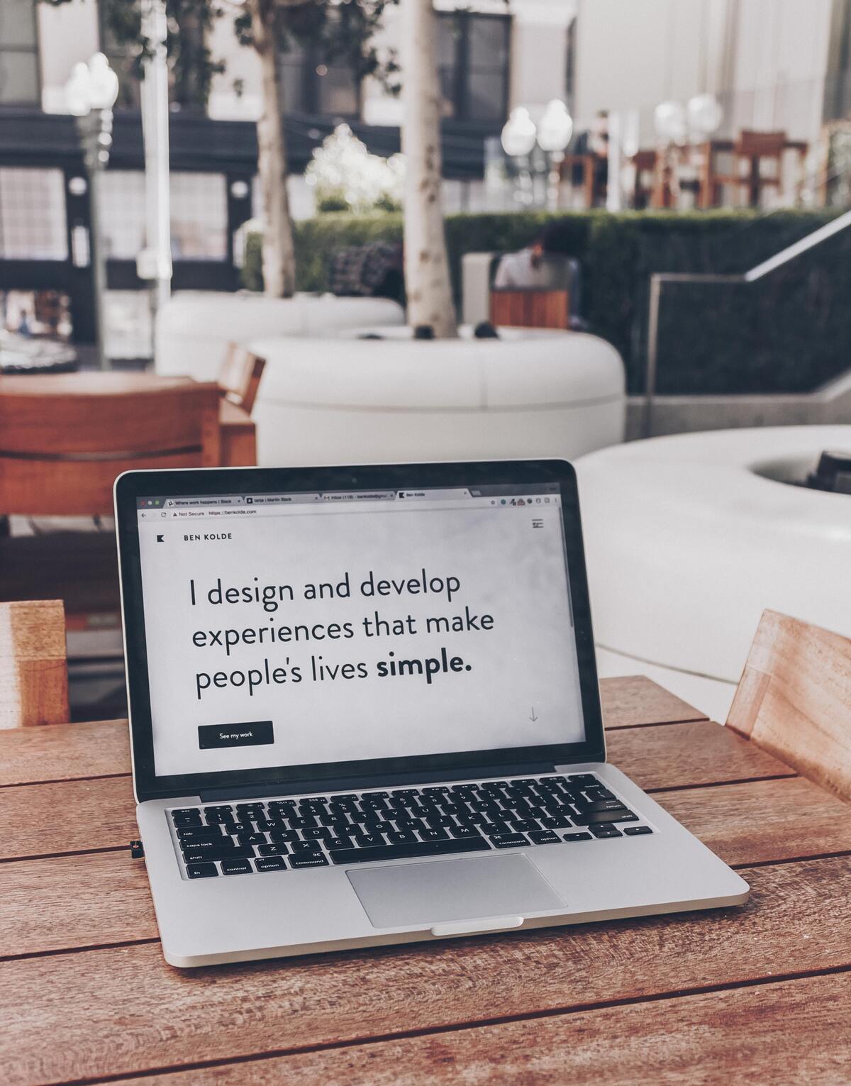 A laptop opens to a portfolio website that says ‘I design and develop experiences that make people’s lives simple.