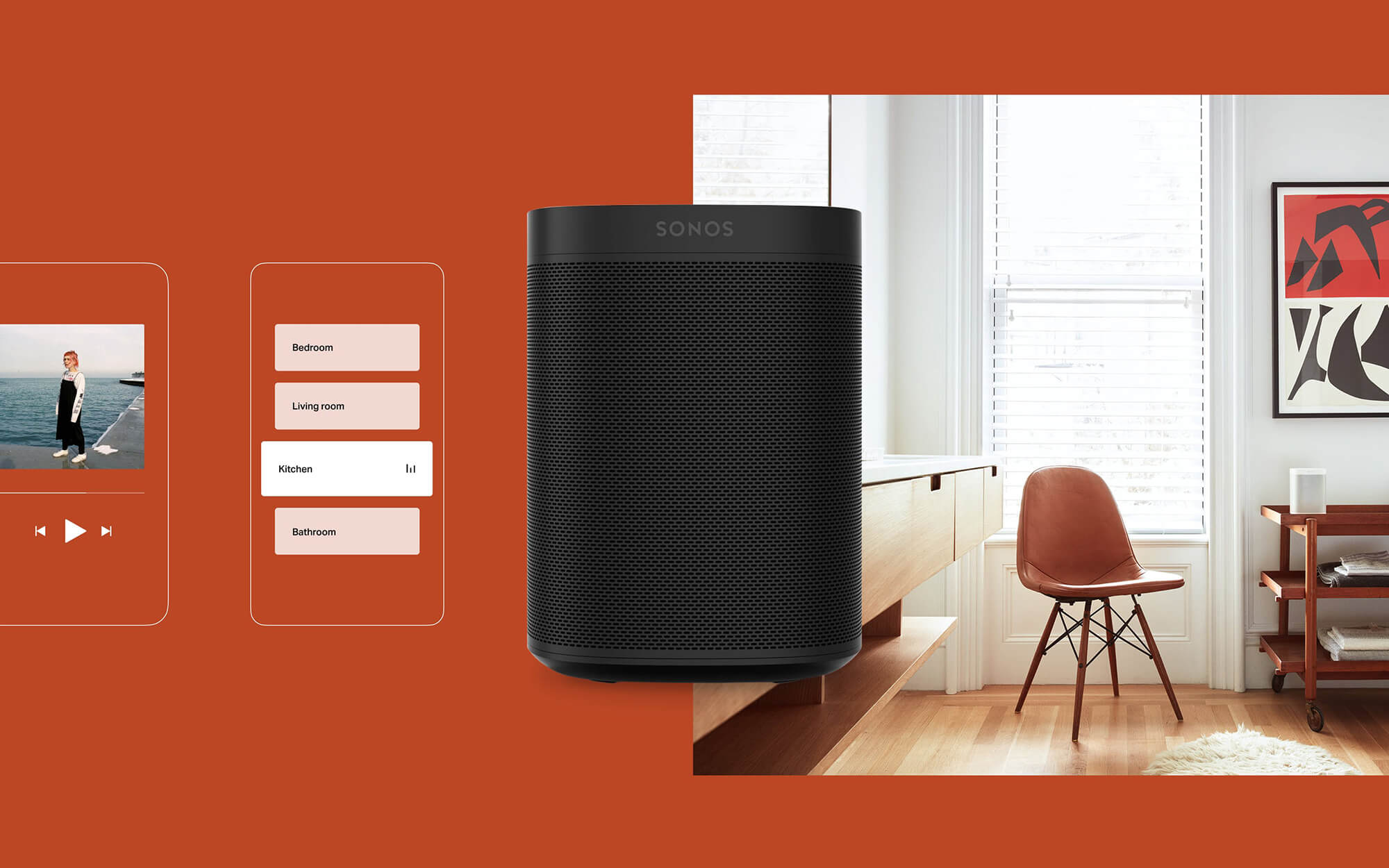 a black speaker is backdropped against a warm orange background and a photo of a cozy living room