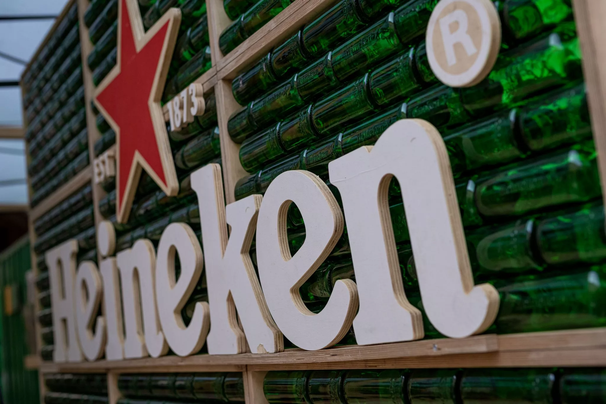 A wall made from stacks of green beer bottles