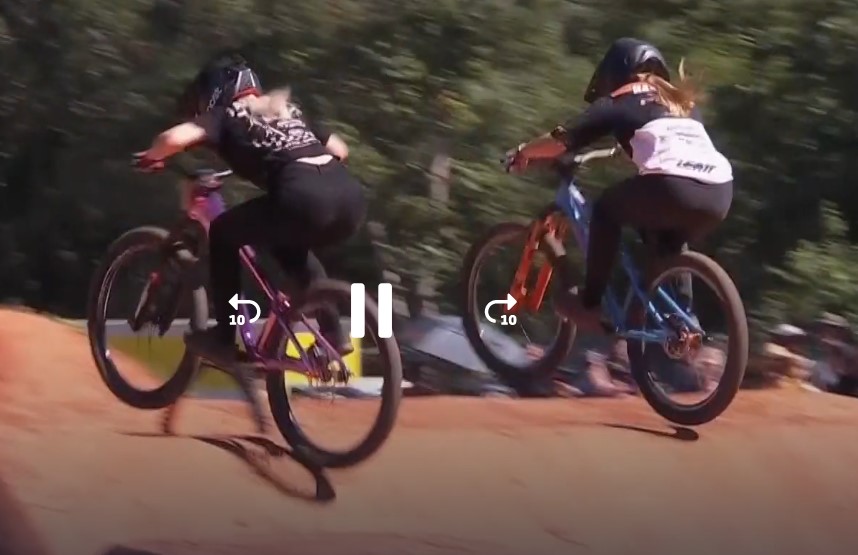 Two women riding their mountain bikes at full speed.