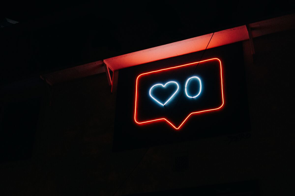 A red neon chatbox sign with a heart and a zero inside