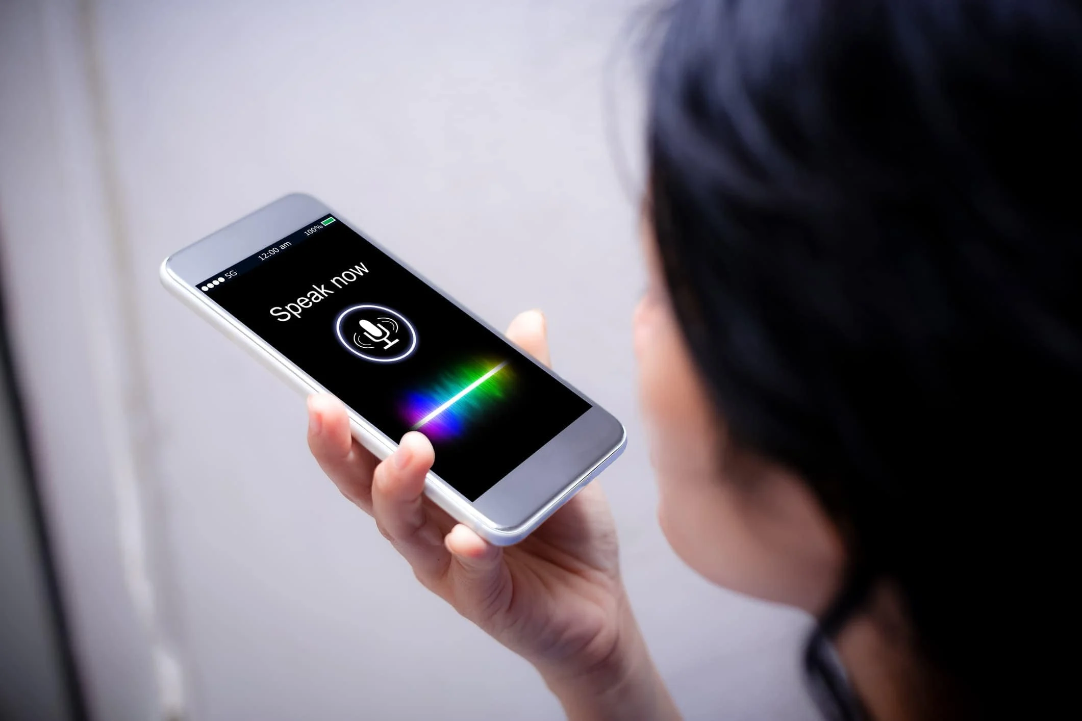 A user interacting with a voice-enabled smart device, demonstrating the convenience of voice commands.