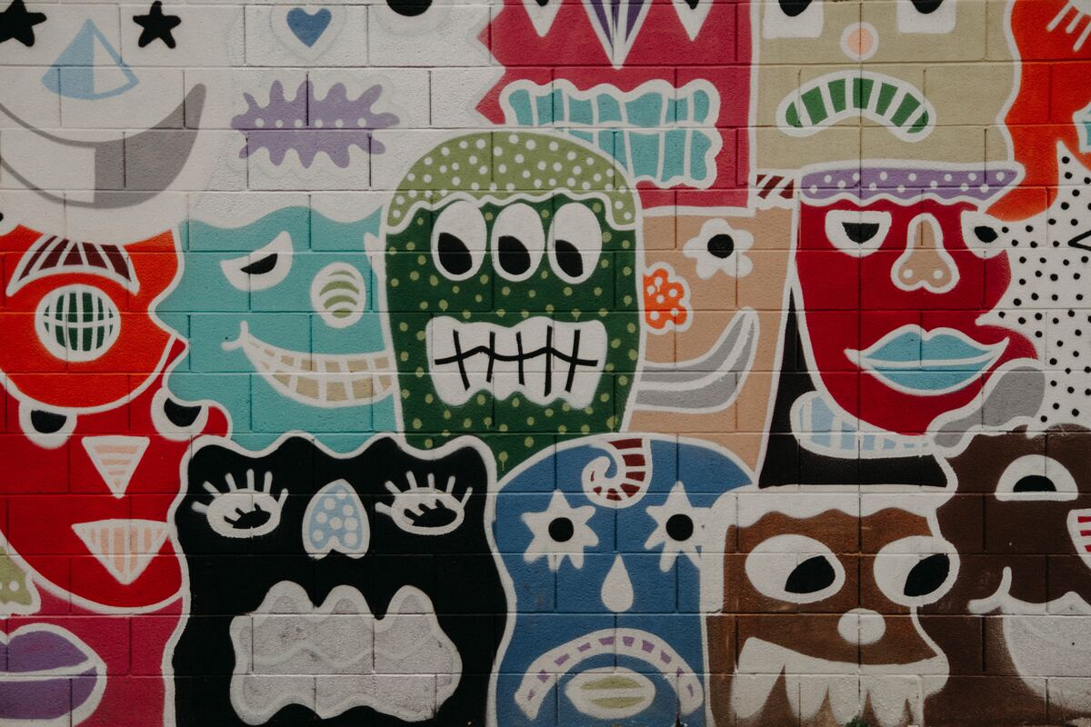A colorful mural of cartoonish characters on a tiled wall