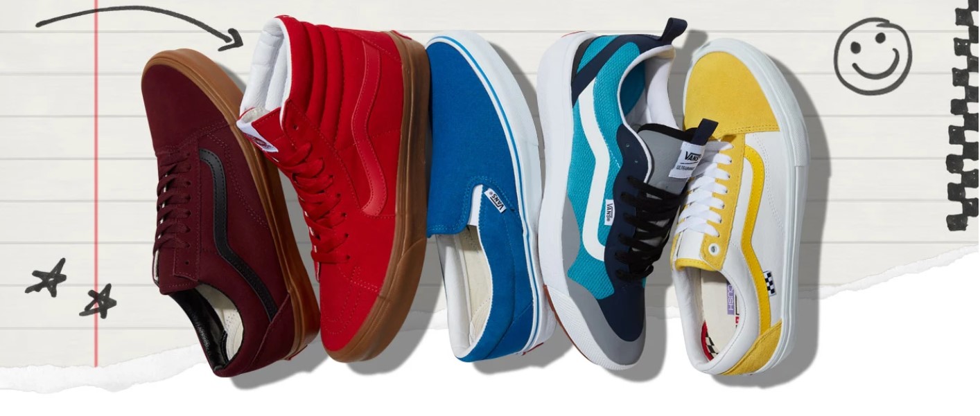 Five sneakers in red, orange, dark blue, light blue, and yellow are laid across a notepad