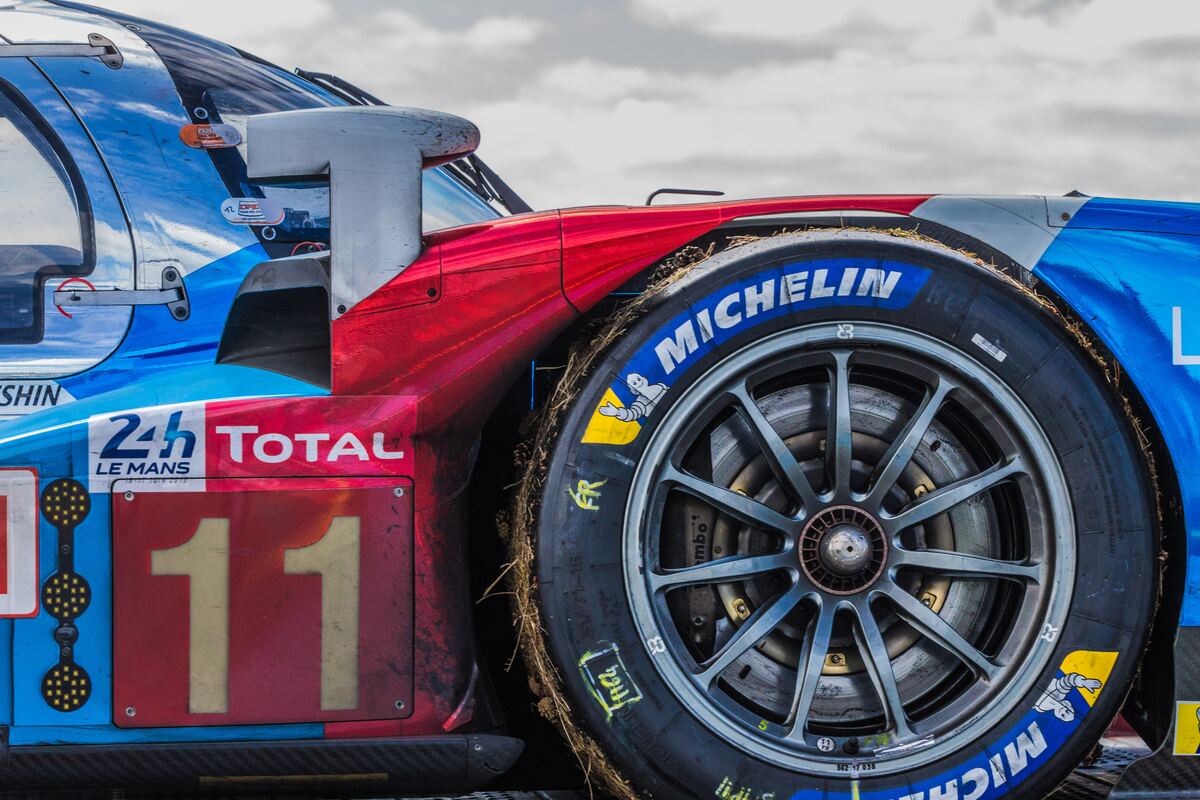 A photo of a car in red and blue with Michelin tires.