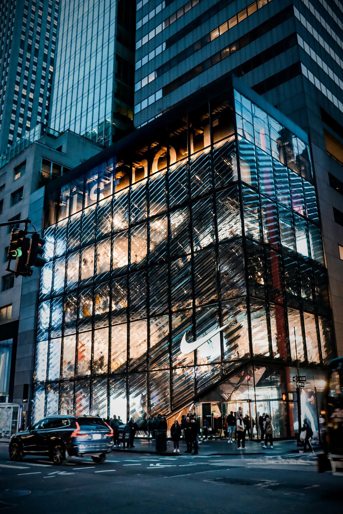 A glass building with a “Just Do It” tagline displayed on the top floor