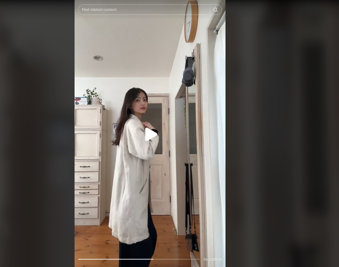 A woman puts on a white coat