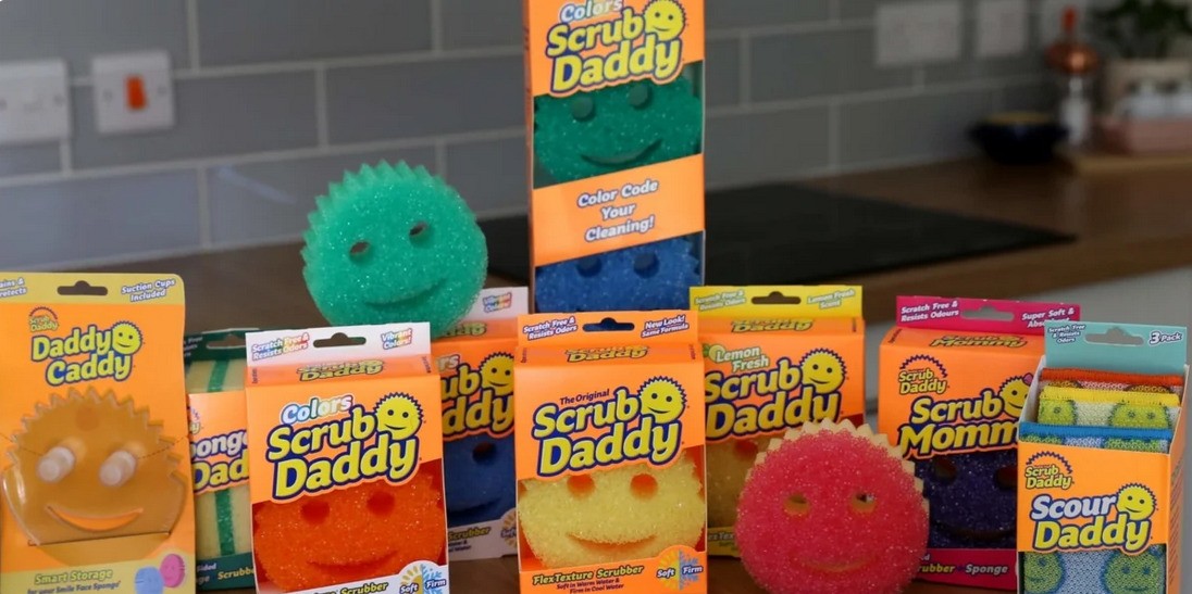 Boxes of colorful dish sponges in orange, red, green, and blue