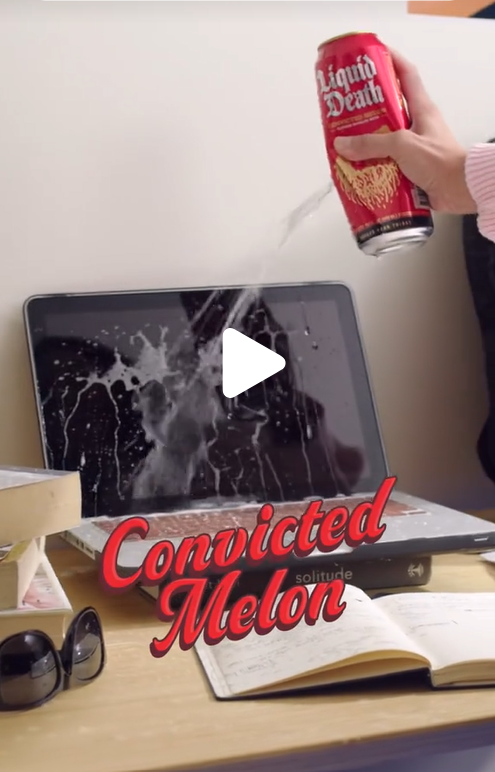A person sprays a canned water on a laptop