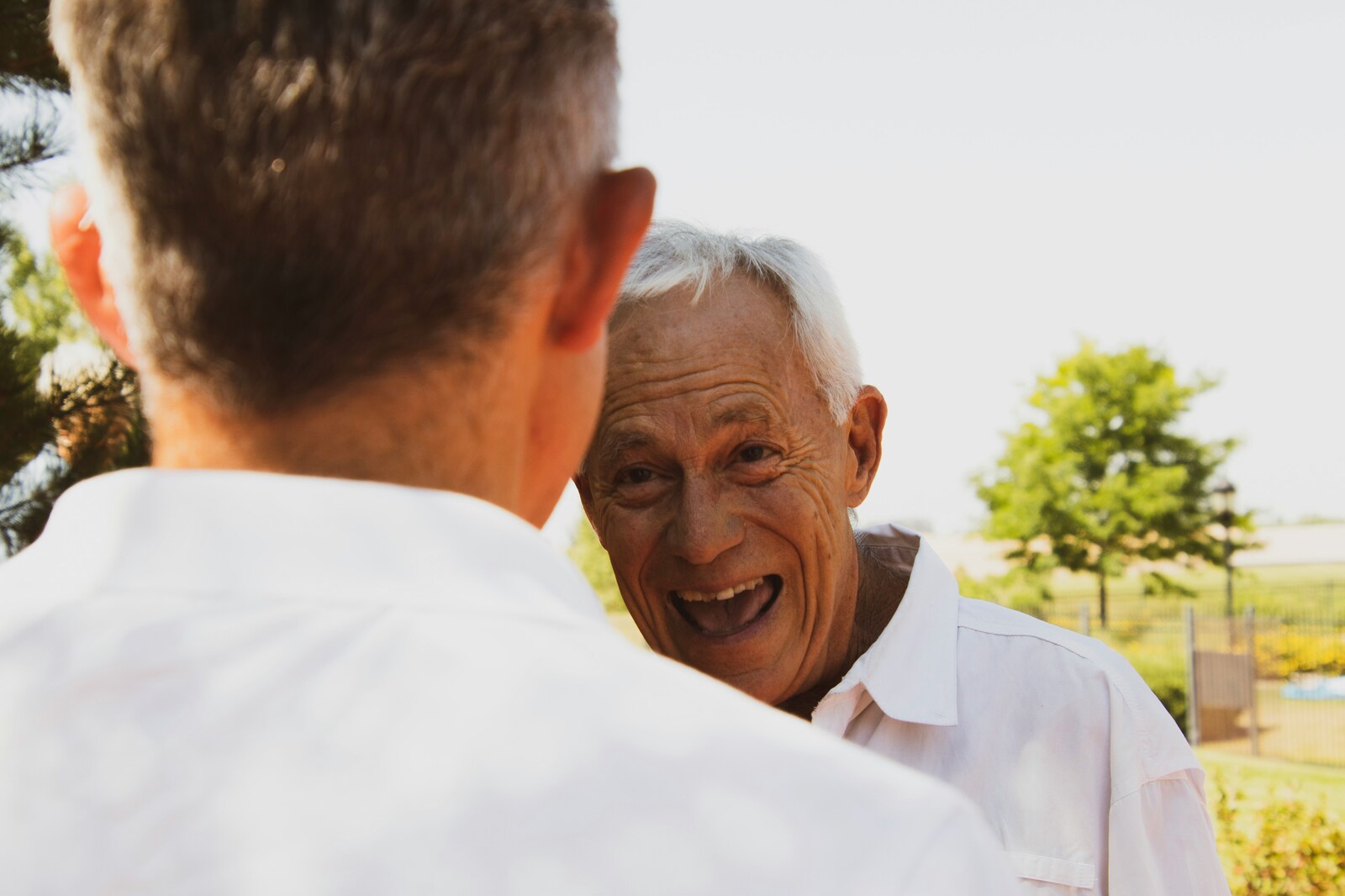 Two old men in white button-up shirts