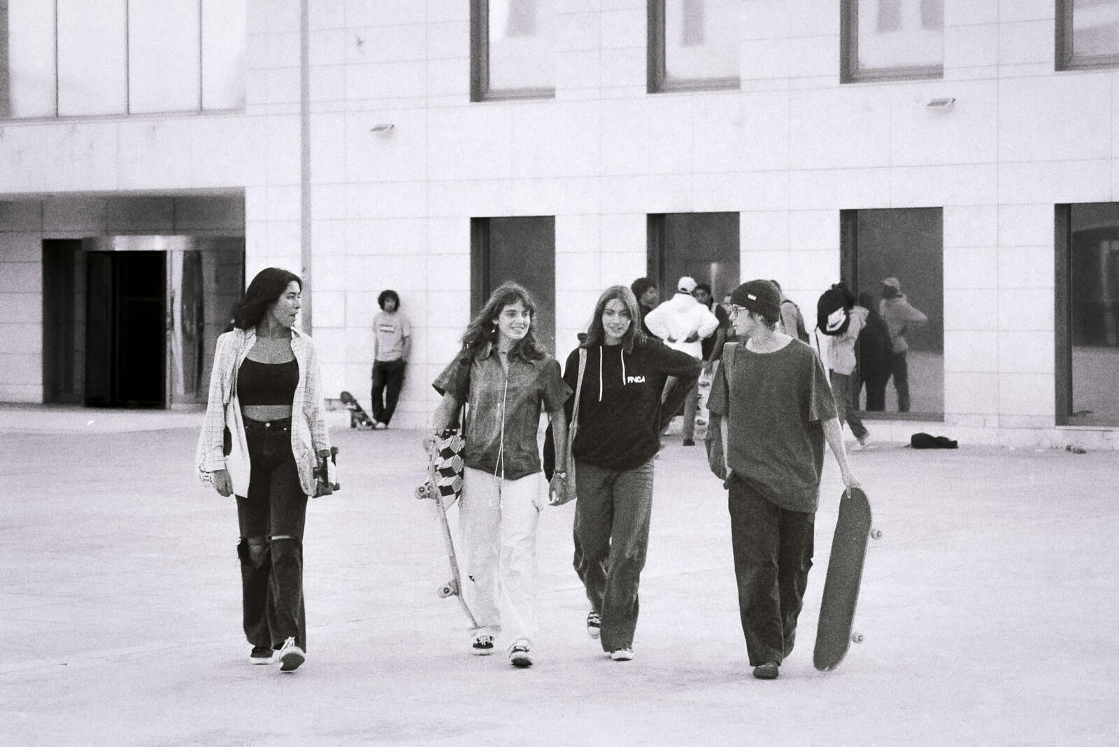 Group of young people wearing crop top, oversized shirts, and baggy pants
