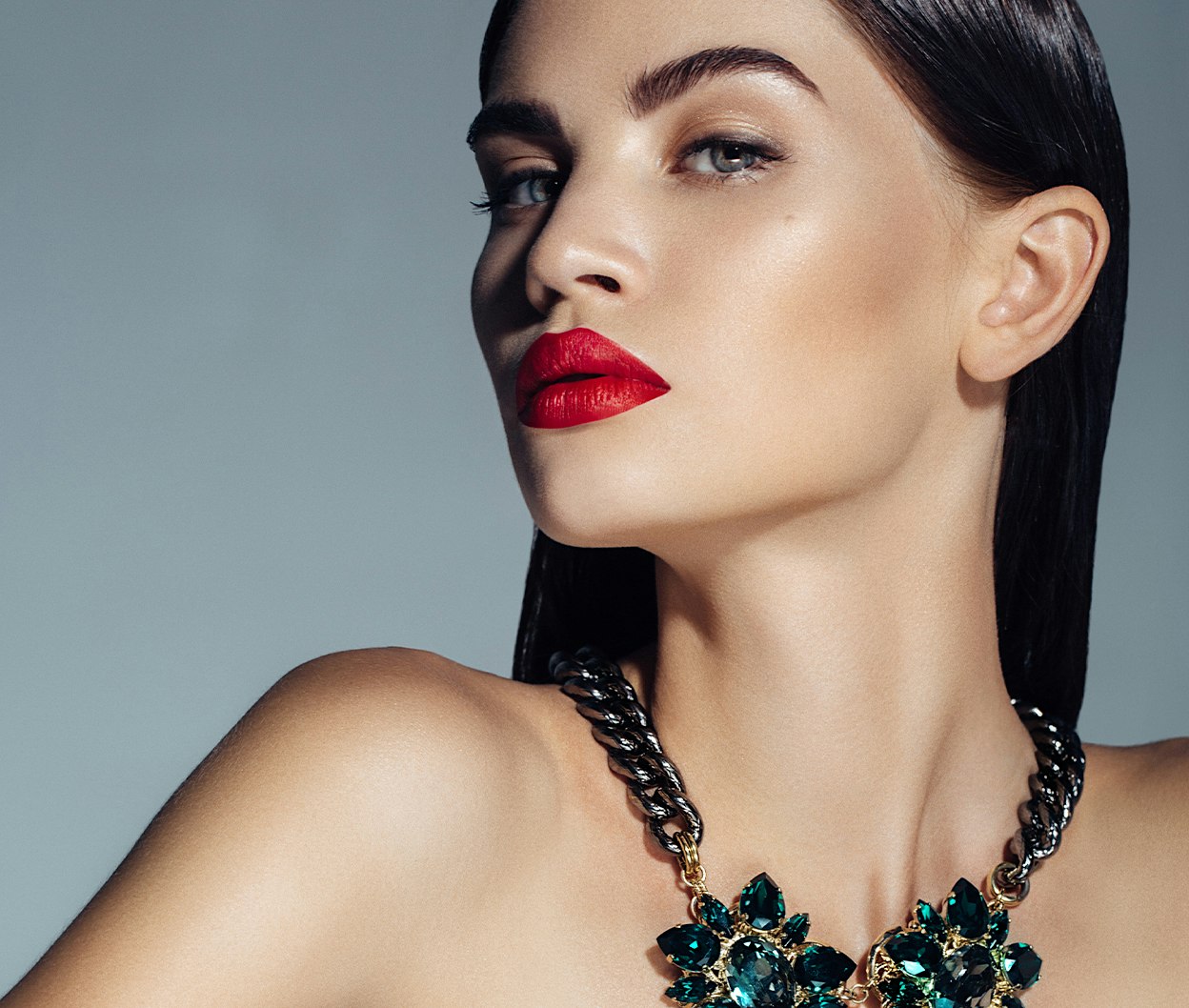 woman wearing makeup and a necklace