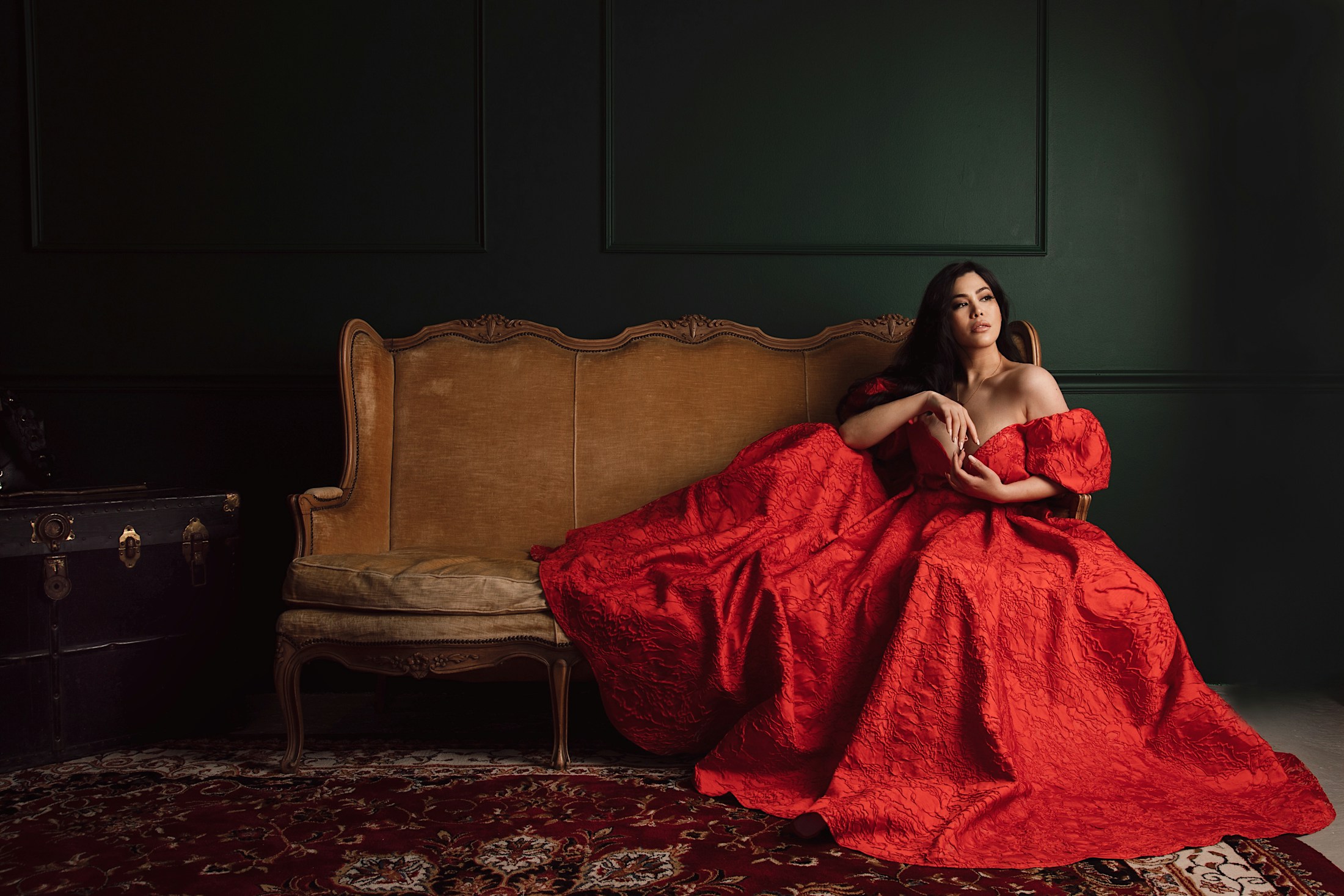 Woman in red dress sitting on couch