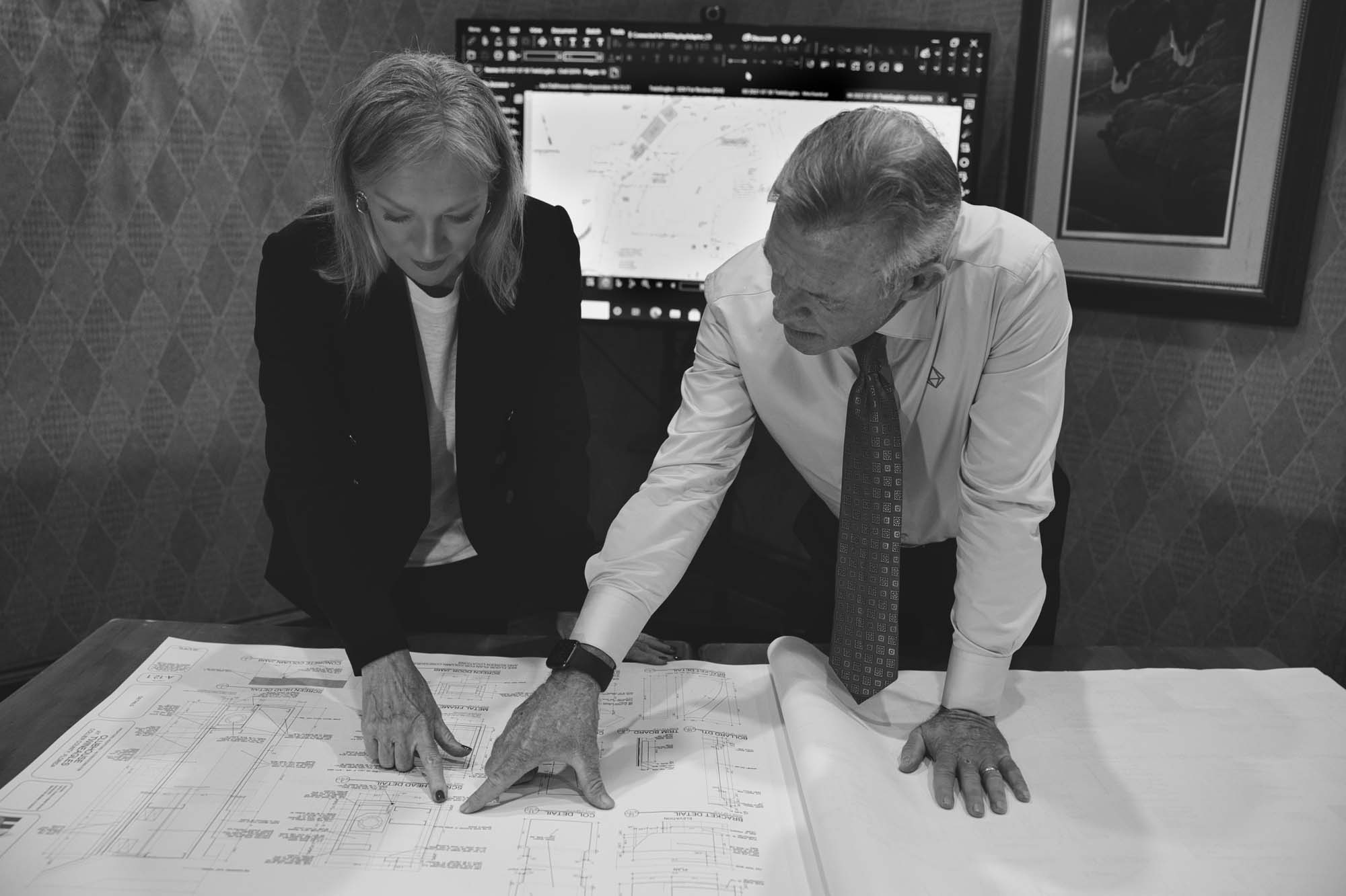 Two people looking at blueprints