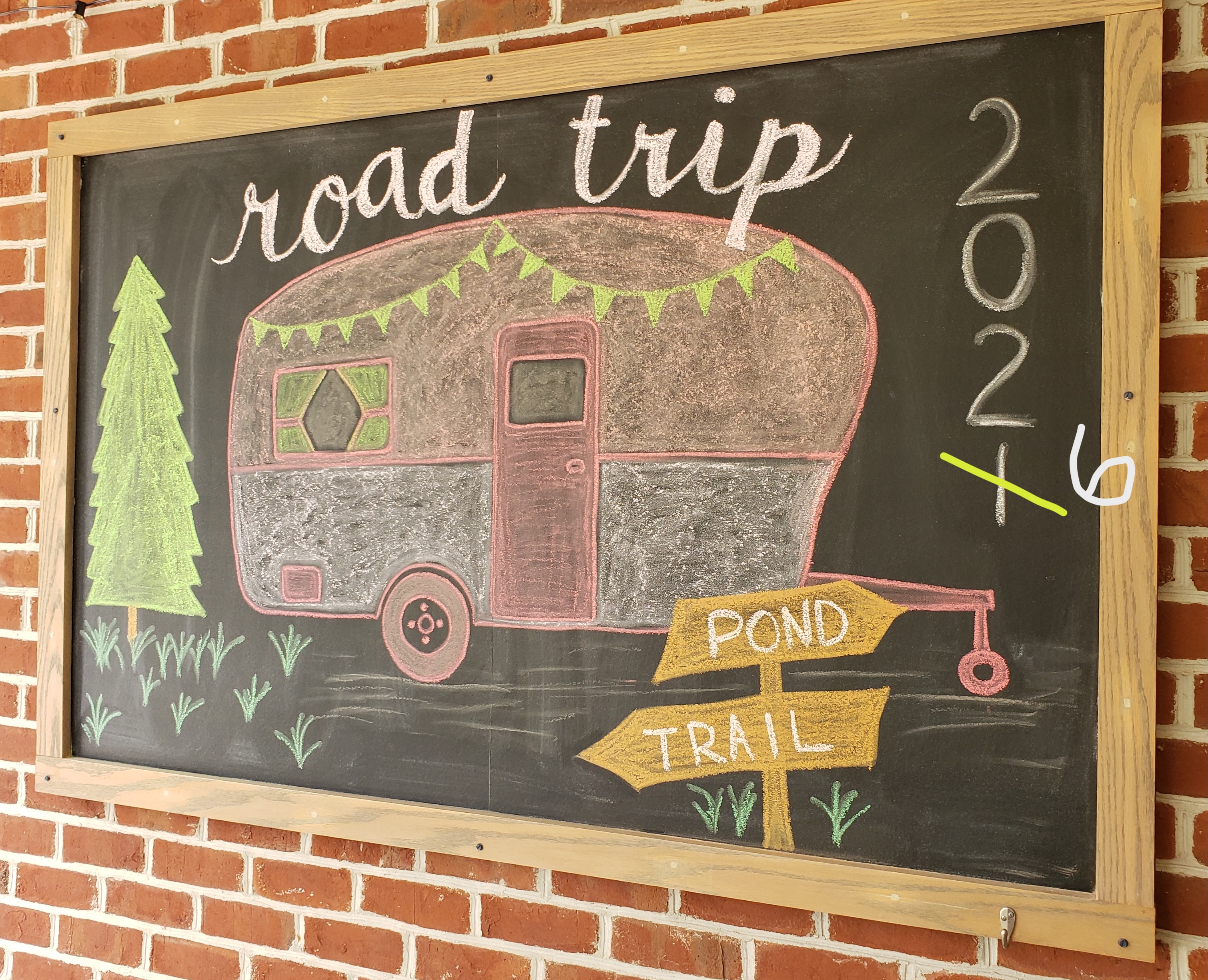 chalkboard drawing of camper with title road trip