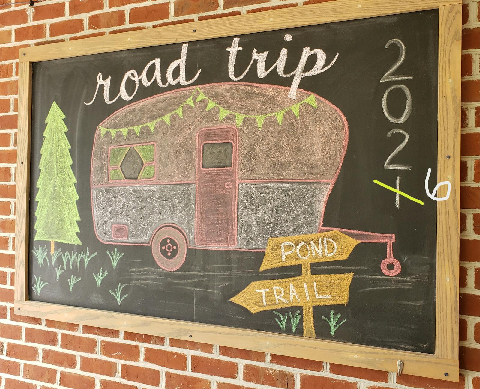 chalkboard drawing of camper with title road trip
