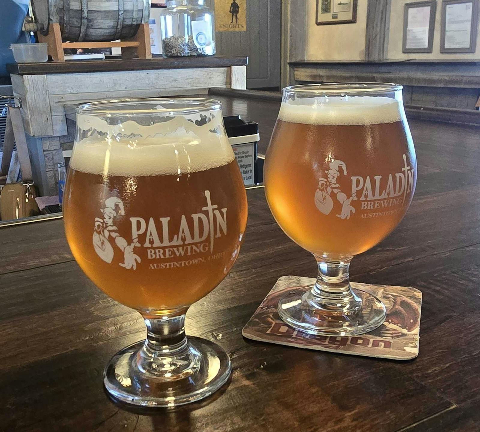 2 glasses of raspberry wheat beer with paladin brewing logo