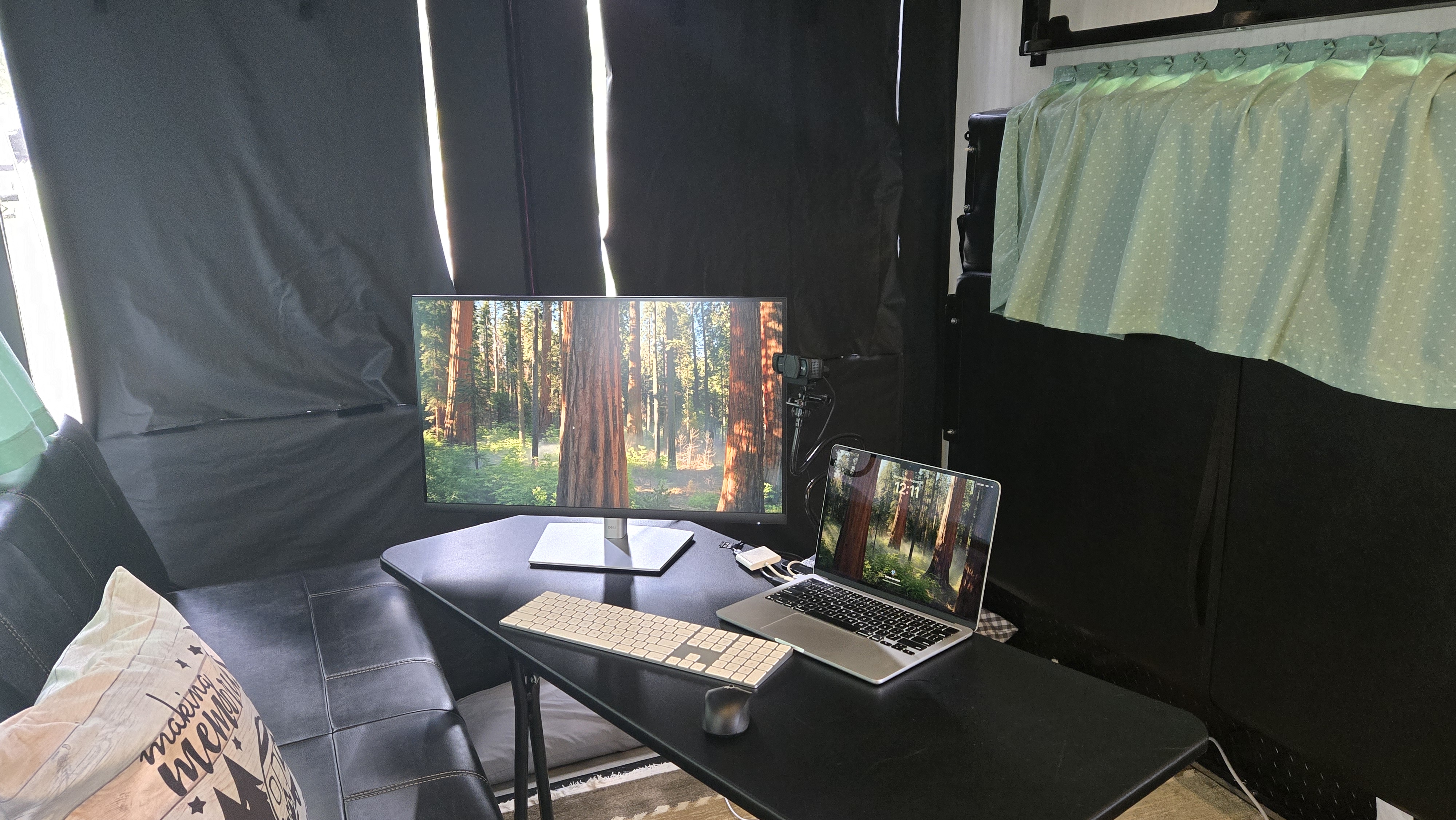 office set up in garage of toy hauler camper with laptop and monitor on small table