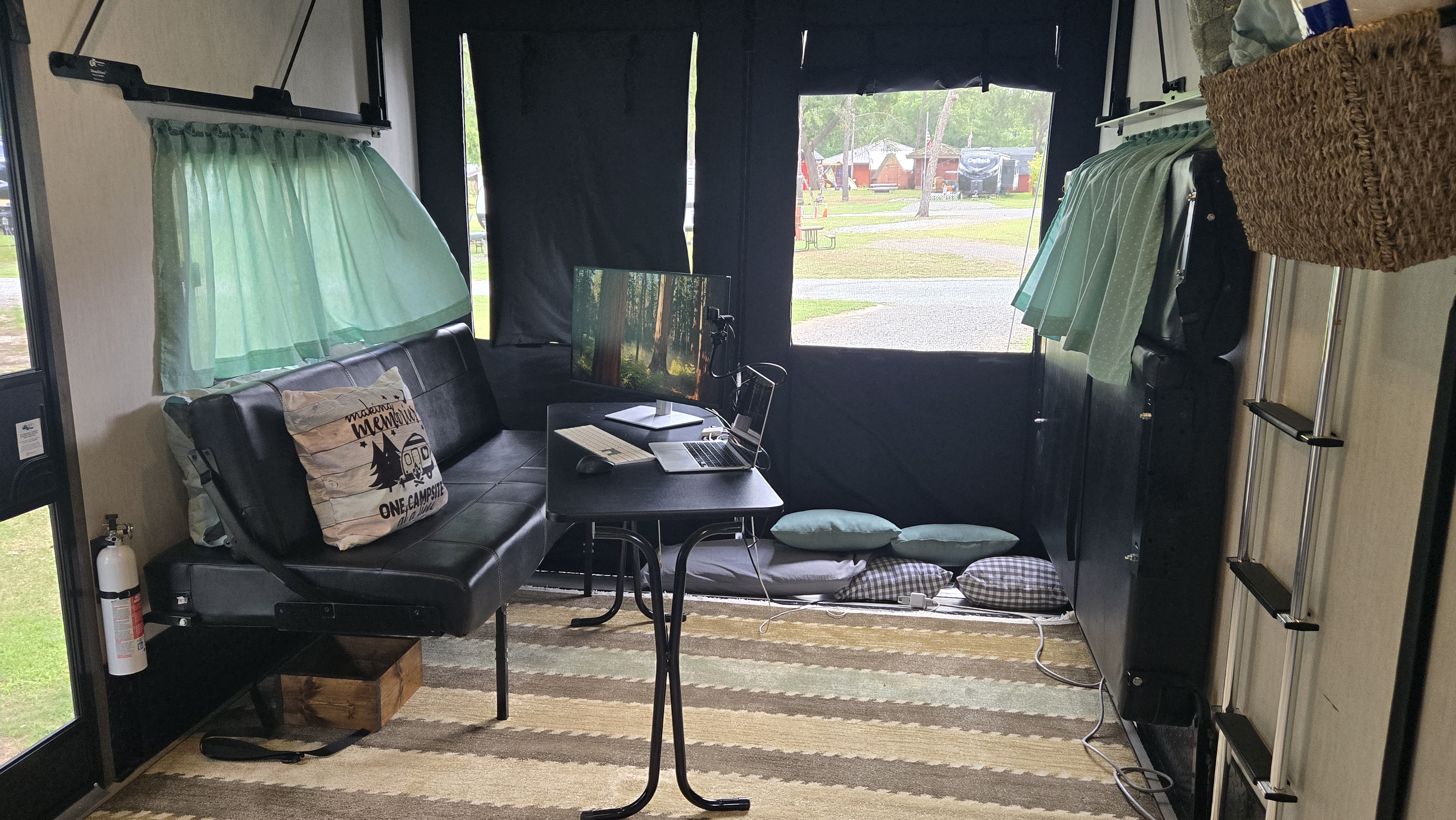 office set up in garage of toy hauler camper with laptop and monitor on small table