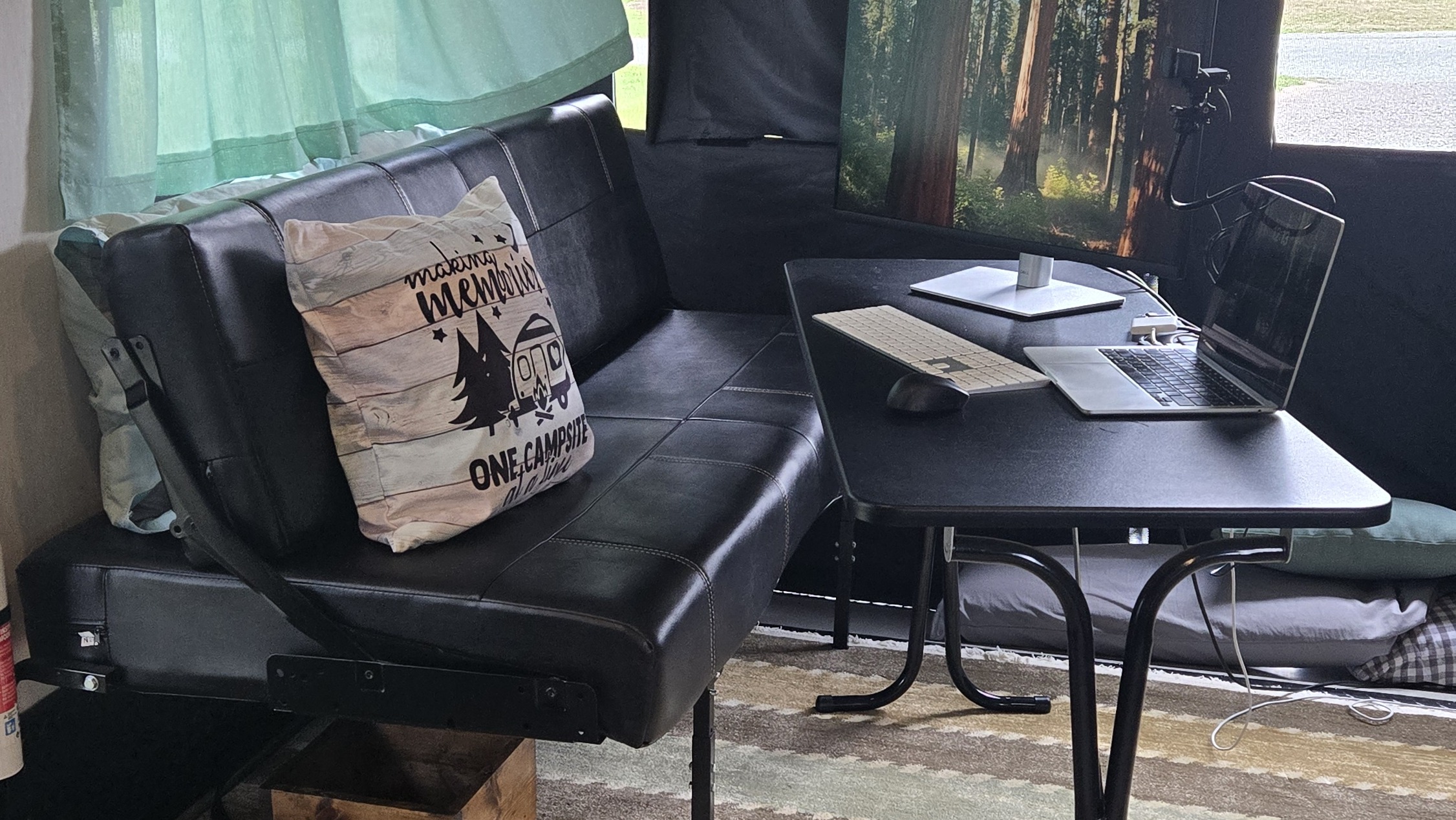 office set up in garage of toy hauler camper with laptop and monitor on small table