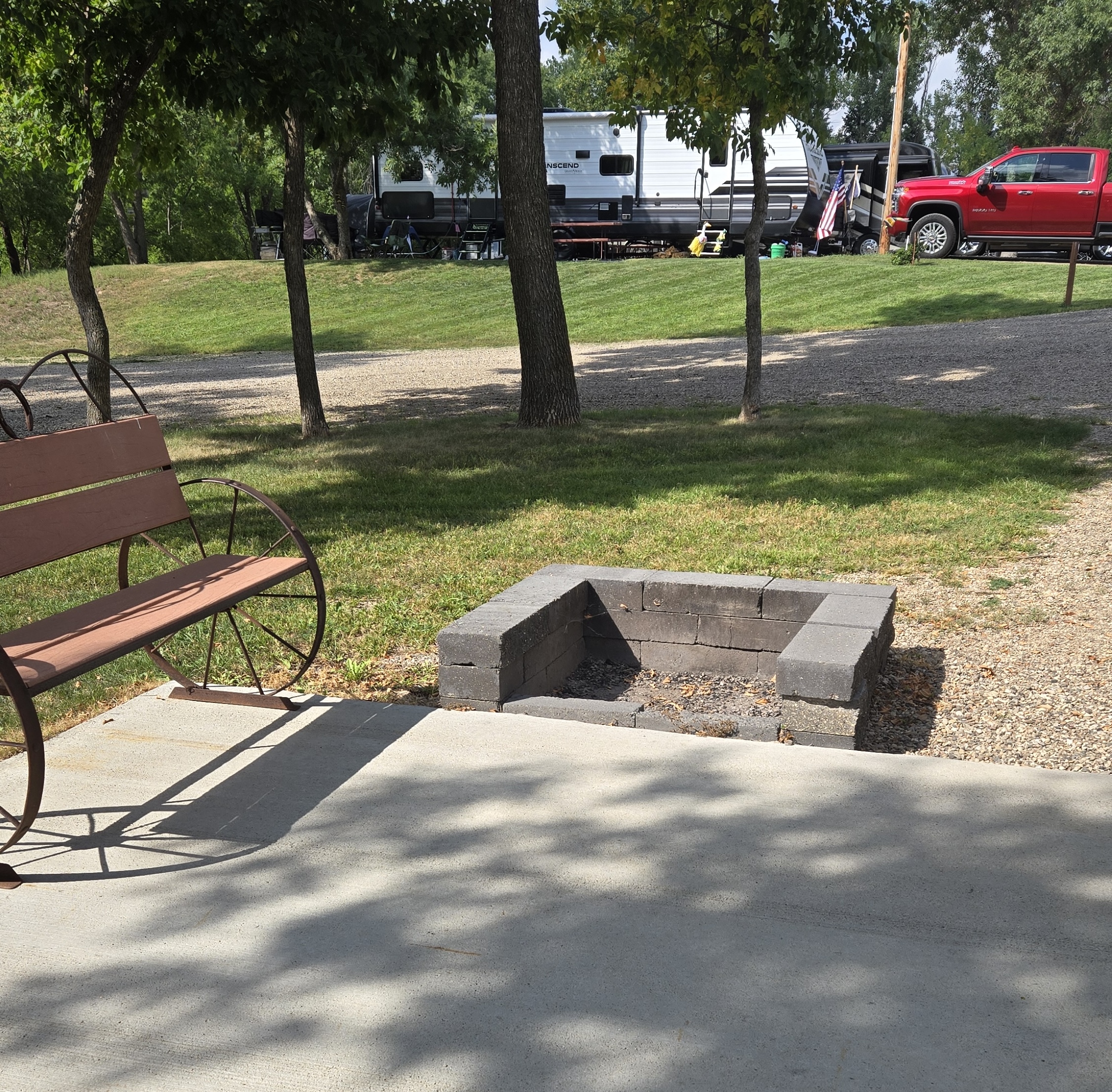 square firepit next to bench seat in campground
