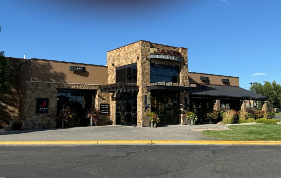 the front of Jake's Bar and Grill manicured lawn, ornamental grass and potted plants