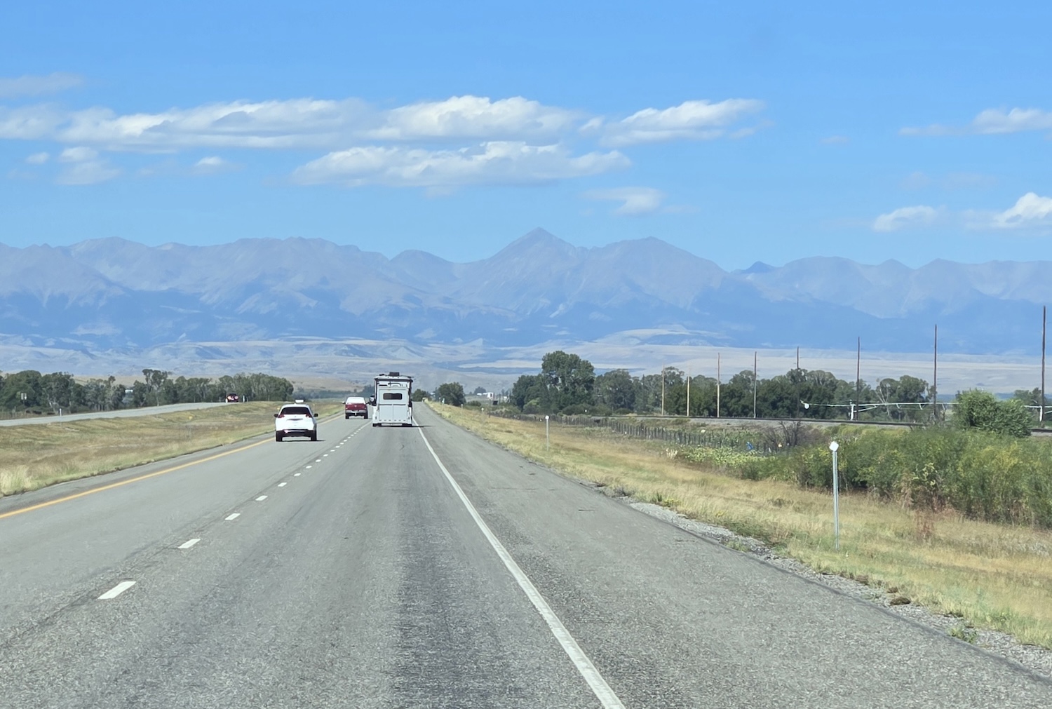94 West highway with Crazy Peak mountain range in the background looking hazy and muted