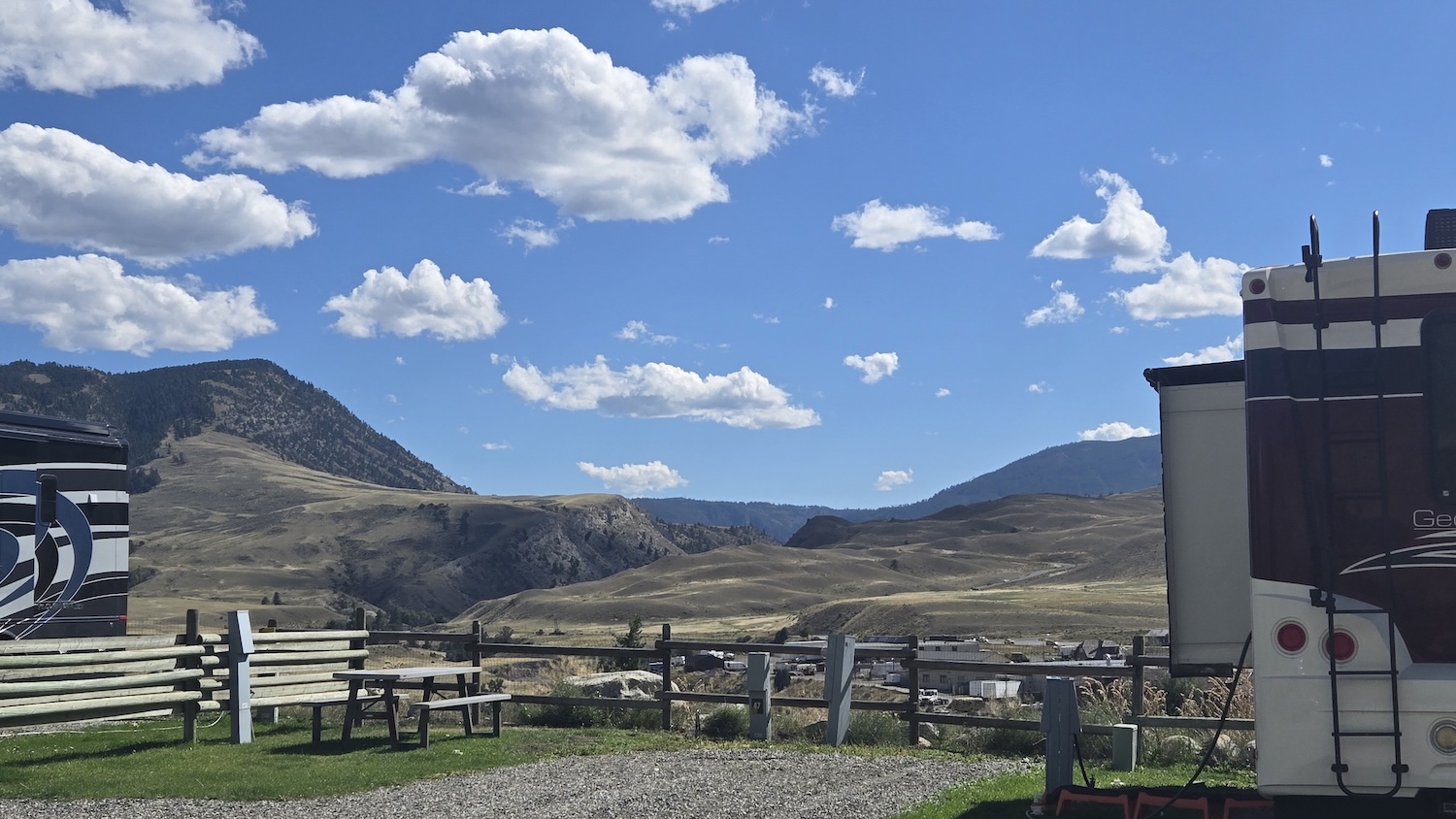 view from campground with campers to left and right and northwestern mountain range of Yellowstone in background