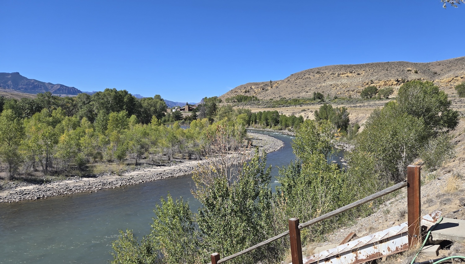 the Shoshone River and tree-lined bank with old metal stairs leading to the water