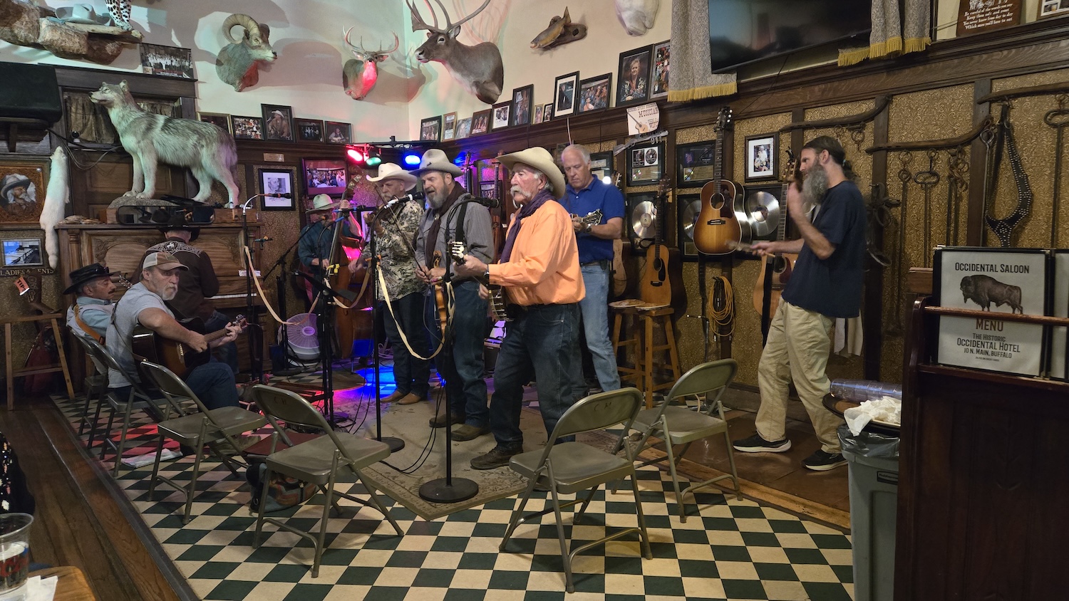 a group of country and bluegrass musicians playing guitars and banjos