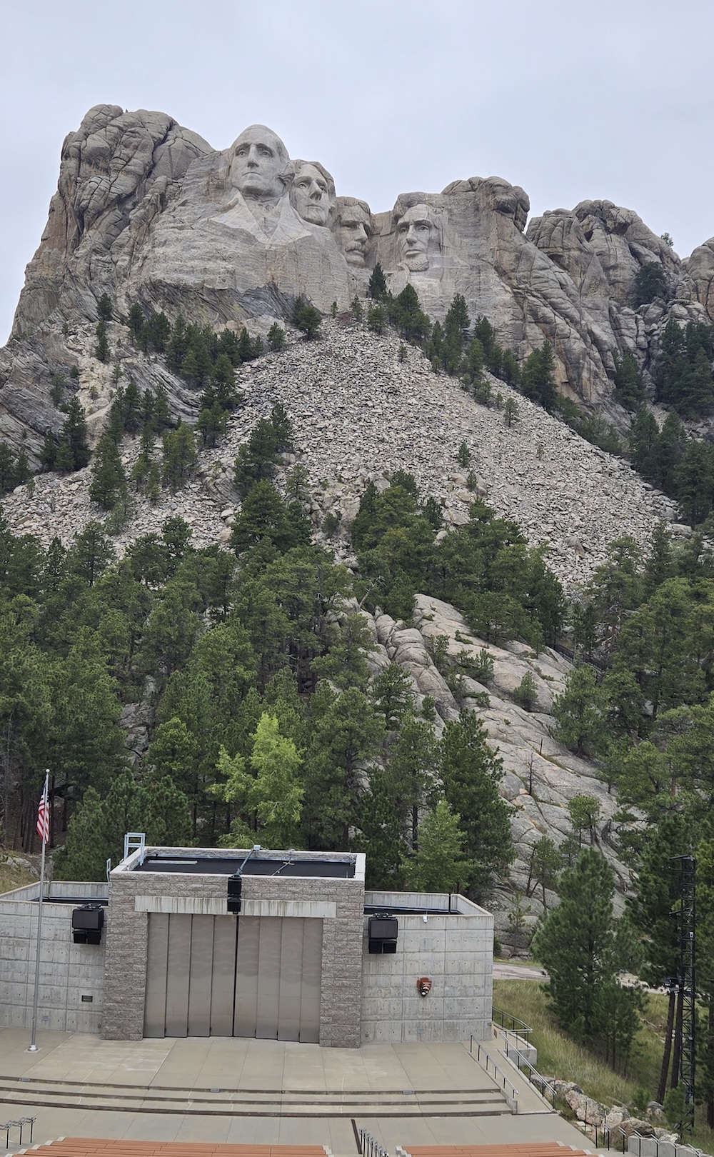 Mount Rushmore on a cloudy day with view of the amphitheater below it