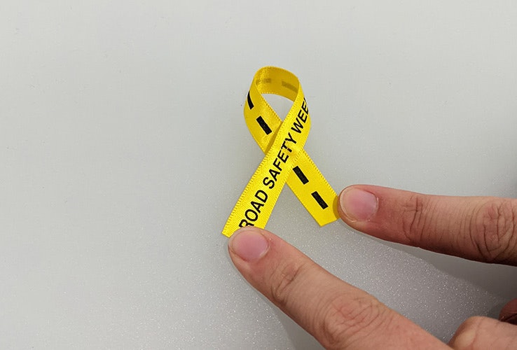 a short piece of yellow ribbon crossed over to make a bow