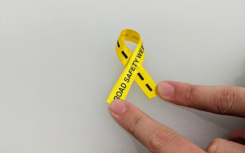 a short piece of yellow ribbon crossed over to make a bow