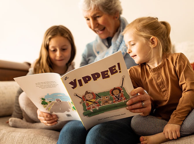 Grandmother with children reading Yippee book