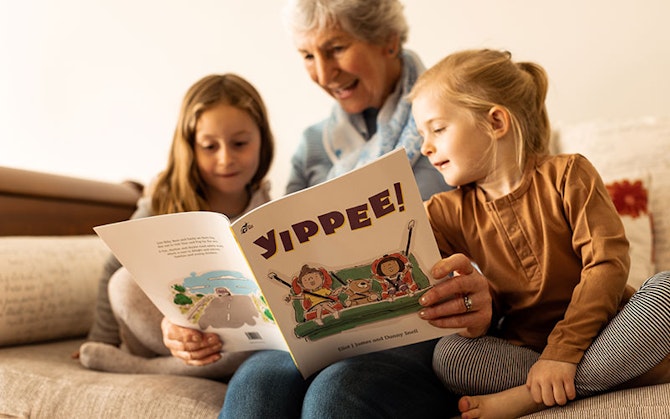 Grandmother with children reading Yippee book