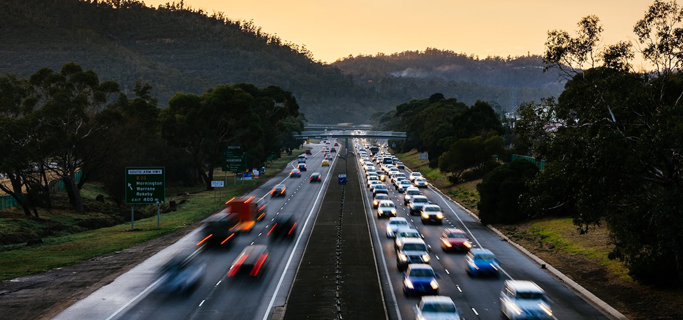 Cars travelling along Tasman Highway at dawn.