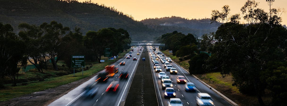 Cars travelling along Tasman Highway at dawn.