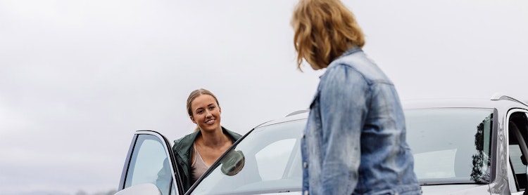 Learner driver getting into car with mother